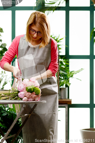 Image of Young florist in flower shop