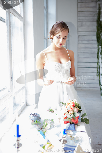 Image of Beautiful bride in wedding dress, white background