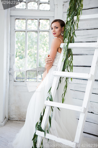 Image of Beautiful bride in wedding dress, white background