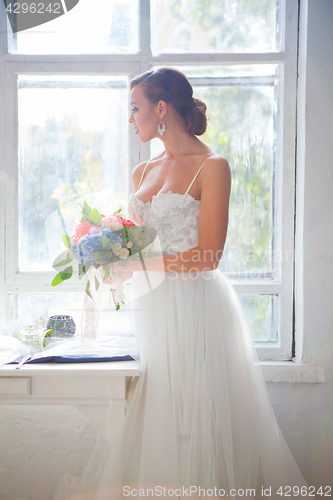Image of Beautiful bride in wedding dress, white background