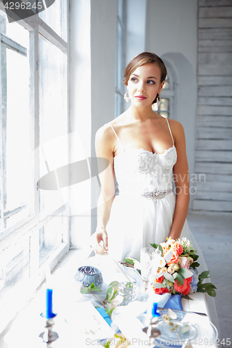 Image of Beautiful bride in wedding dress, white background