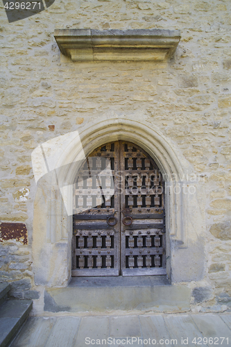 Image of Stone wall with barred wooden door