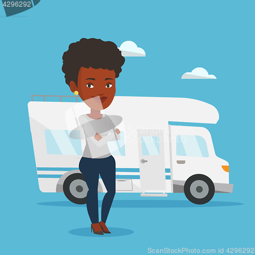 Image of Woman standing in front of motor home.