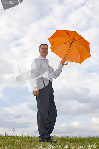 Image of Businessman with orange umbrella