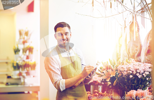 Image of florist man with clipboard at flower shop