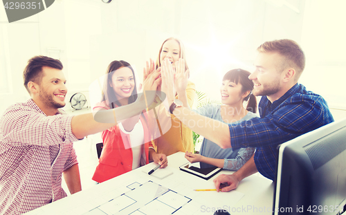 Image of creative team making high five at office