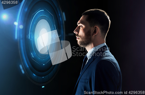 Image of businessman looking at virtual projection