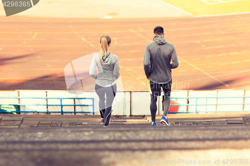 Image of couple running downstairs on stadium