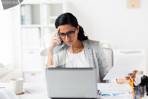 Image of stressed businesswoman with laptop at office