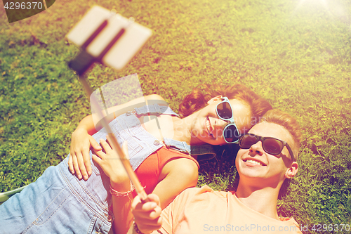 Image of happy couple taking selfie on smartphone at summer