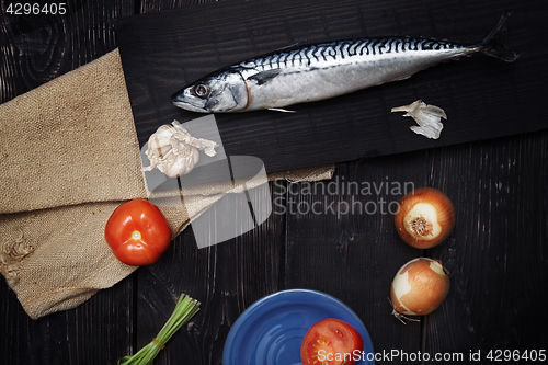 Image of Mackerel and vegetables on a wooden table