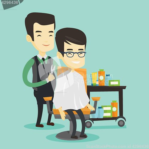 Image of Barber making haircut to young asian man.