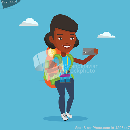 Image of Woman with backpack making selfie.