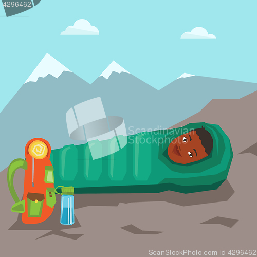 Image of Woman resting in sleeping bag in the mountains.