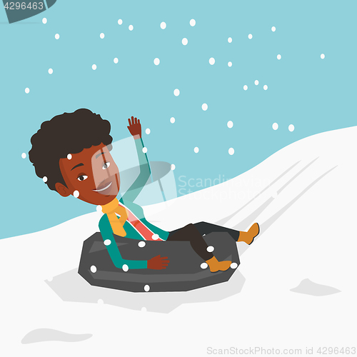 Image of Woman sledding on snow rubber tube in mountains.