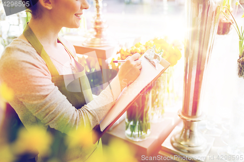 Image of close up of woman with clipboard at flower shop