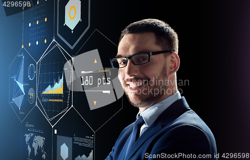 Image of smiling businessman in glasses over black