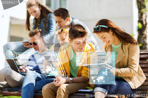 Image of happy students or friends with tablet pc outdoors