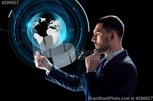 Image of businessman with tablet pc and virtual globe