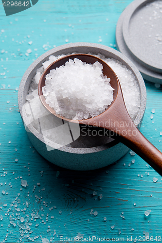 Image of sea salt in stone bowl and wooden spoon