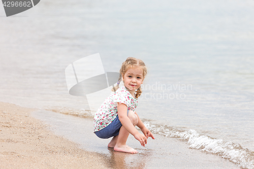 Image of The girl on the sea beach.