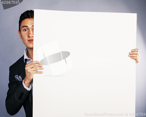 Image of pretty cool european businessman holding empty white plate smili