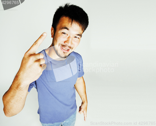 Image of young cute asian man on white background gesturing emotional, po