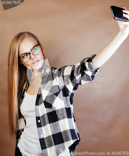 Image of young happy smiling hipster blond girl with backpack ready to sc