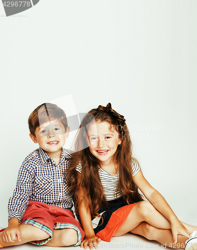 Image of little cute boy and girl hugging playing on white background, ha