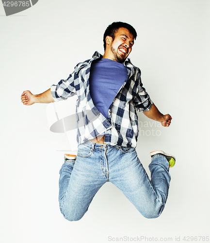 Image of young pretty asian man jumping cheerful against white background