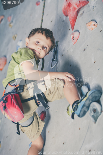 Image of little boy climbing a rock wall