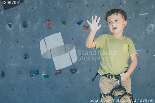 Image of little boy climbing a rock wall