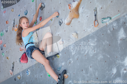 Image of teenager climbing a rock wall