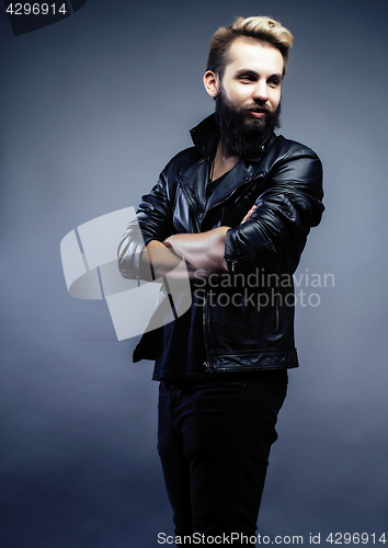 Image of portrait of young bearded hipster guy on gray dark background close up, brutal modern man, lifestyle people concept 