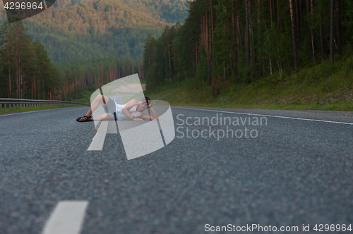 Image of Man laying on the road