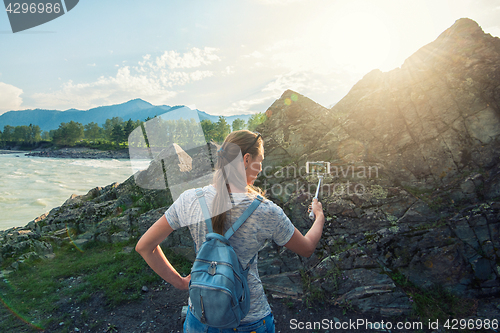 Image of Woman taking selfie on mobile phone