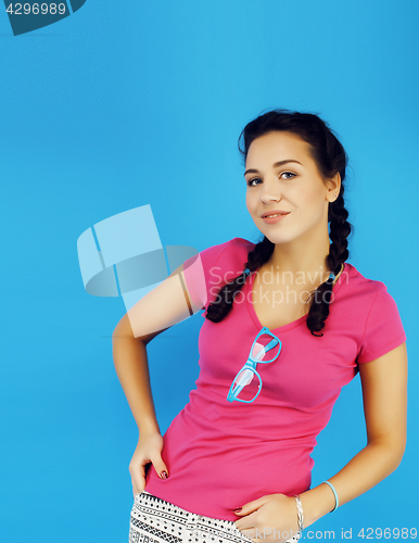 Image of young pretty teenage modern hipster girl posing emotional happy smiling on blue background, lifestyle people concept 