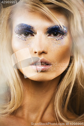 Image of beauty young snow queen lady in fairy flashes with hair crown on her head close up in cold blue light
