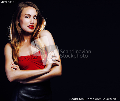 Image of young blond real woman emotional posing on black background copyspace dark indoor, blifestyle people concept