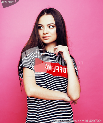 Image of young pretty teenage woman emotional posing on pink background, fashion lifestyle people concept 