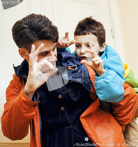 Image of Young father hipster and his little son outside. Talking, teaching, hugging, having fun happy time. Lifestyle people concept 