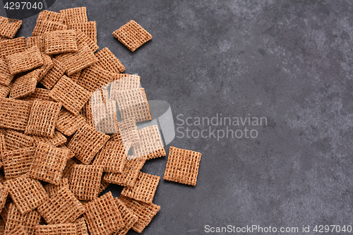 Image of Malted shredded wheat biscuits breakfast cereal on grey slate ba