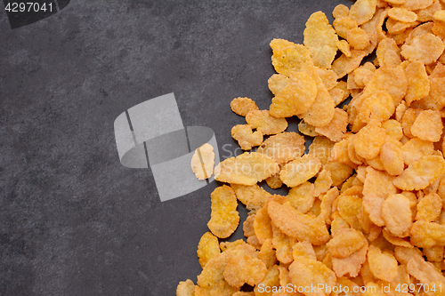 Image of Corn flakes breakfast cereal in diagonal line on grey slate