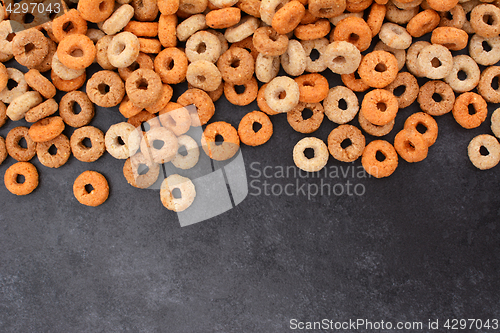 Image of Multigrain hoops breakfast cereal border on dark grey slate