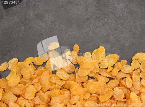 Image of Corn flakes breakfast cereal line on a grey slate