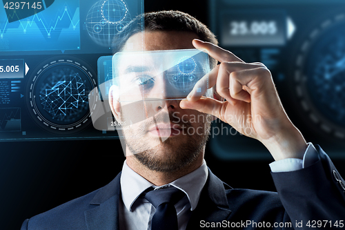 Image of businessman with smartphone and virtual holograms
