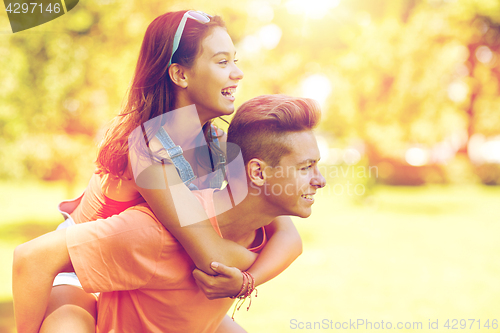 Image of happy teenage couple having fun at summer park