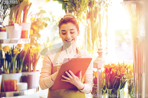 Image of florist woman with clipboard at flower shop