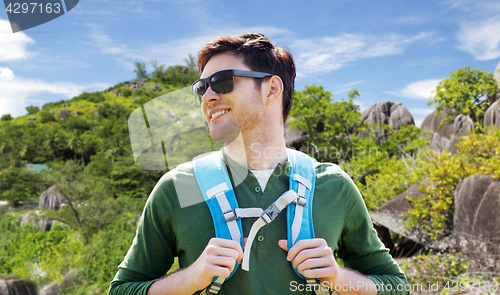 Image of happy man with backpack traveling over island