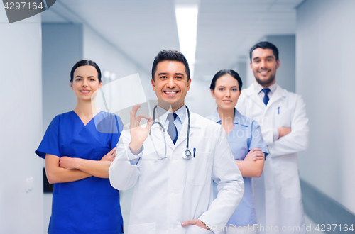 Image of group of medics at hospital showing ok hand sign